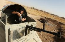 A member of the peshmerga forces takes his position with his weapon during preparations to attack Mosul, on the outskirt of Mosul during preparations to attack Mosul, Iraq, October 15, 2016. PHOTO BY REUTERS/Ari Jalal