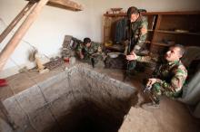Peshmerga forces stand around a tunnel used by Islamic State militants on the outskirts of Bartila, east of Mosul, during an operation to attack Islamic State militants in Mosul. PHOTO BY REUTERS/Azad Lashkari
