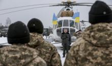 Ukrainian President Petro Poroshenko (C) listens to the state anthem as he visits the Yavoriv military range outside Lviv, western Ukraine, December 30, 2014. PHOTO BY REUTERS/Ukrainian Presidential Press Service
