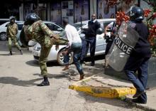 Kenyan policemen beat a protester during clashes in Nairobi, Kenya, May 16, 2016. PHOTO BY REUTERS/Goran Tomasevic