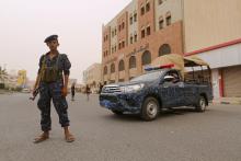 A pro-Houthi police trooper stands past a patrol vehicle in the Red Sea port city of Hodeidah, Yemen, June 14, 2018. PHOTO BY REUTERS/Abduljabbar Zeyad