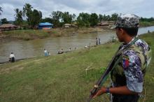 A Myanmar border guard police officer stands guard in Tin May village, Buthidaung township, northern Rakhine state, Myanmar, July 14, 2017. PHOTO BY REUTERS/Simon Lewis