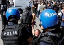 Riot police detain a protester during the trial of two Turkish teachers, who went on a hunger strike over their dismissal under a government decree following last year's failed coup, outside of a courthouse in Ankara, Turkey, September 14, 2017. PHOTO BY REUTERS/Umit Bektas