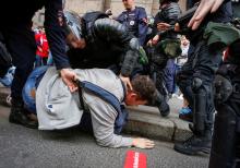 Police officers detain a protester during a rally against planned increases to the nationwide pension age in St. Petersburg, Russia. PHOTO BY REUTERS/Anton Vaganov