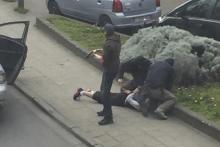 Police officers detain a suspect during a raid in which fugitive Mohamed Abrini was arrested in Anderlecht, near Brussels, Belgium, April 8, 2016 in this still image taken from video. PHOTO BY REUTERS/Sebastien Dana-Kamran via Reuters TV