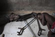 Youths suffering from polio sleep beside crutches at the Stand Proud compound in Kinshasa. PHOTO BY REUTERS/Finbarr O'Reilly