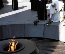 Pope Francis leaves two roses as he attends the ceremony in commemoration of Armenians killed by Ottoman forces during World War One at the Tzitzernakaberd Genocide Memorial in Yerevan, Armenia, June 25, 2016. PHOTO BY REUTERS/Maurizio Brambatti