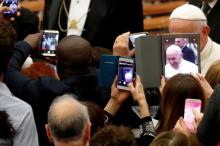 People take photos as Pope Francis attends a special audience with members of a volunteers association from Sardinia island in the Paul VI Hall at the Vatican, November 30, 2018. PHOTO BY REUTERS/Max Rossi