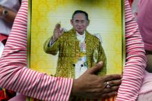 A well-wisher hugs a portrait of Thailand's King Bhumibol Adulyadej at the Siriraj hospital where he is residing in Bangkok, Thailand, October 13, 2016. PHOTO BY REUTERS/Chaiwat Subprasom