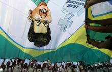 Demonstrators wave a flag with a draw of Brazil's President Dilma Rousseff during an anti-government demonstration in Copacabana in Rio de Janeiro, April 12, 2015. PHOTO BY REUTERS/Ricardo Moraes