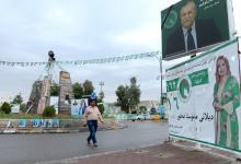 A man walks past a campaign poster ahead of the parliamentary election in Kirkuk, Iraq, May 11, 2018. PHOTO BY REUTERS/Ako Rasheed