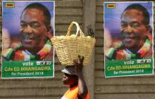 A street vendor carries fruit outside an election rally of President Emmerson Mnangagwa's ruling ZANU PF party in Mutare, Zimbabwe, May 19, 2018. PHOTO BY REUTERS/Philimon Bulawayo