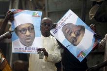 Supporters of presidential candidate Muhammadu Buhari hold his election posters in Kano, March 27, 2015. PHOTO BY REUTERS/Goran Tomasevic