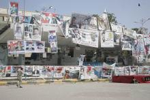 A soldier walks past posters of slain supporters of the separatist Southern Movement at a protest camp set up by the movement to demand the secession of south Yemen, in the southern port city of Aden, February 13, 2015. PHOTO BY REUTERS/Yaser Hasan