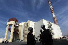 Iranian workers stand in front of the Bushehr nuclear power plant, about 1,200 km (746 miles) south of Tehran, October 26, 2010. PHOTO BY REUTERS/Mehr News Agency/Majid Asgaripour