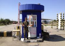An armed pro-Russian separatist stands guard at a border checkpoint near the territory of Russia in Izvaryne, Luhansk region