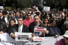 Chilean Deputy Fidel Espinoza (R) and citizens protest as Bishop Juan Barros (not pictured) attends his first religious service inside the Osorno cathedral, south of Santiago, Chile, March 21, 2015. PHOTO BY REUTERS/Carlos Gutierrez
