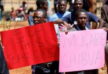 Opposition party supporters hold placards during a court appearance of those arrested following Friday's protest march, in Harare, Zimbabwe, August 29, 2016. PHOTO BY REUTERS/Philimon Bulawayo