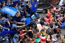 Various activist and Indigenous People's (IP) groups clash with anti-riot policemen during a protest against the continuing presence of U.S. troops in the Philippines in front of the U.S. Embassy in metro Manila, Philippines October 19, 2016. PHOTO BY REUTERS/Romeo Ranoco