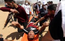A wounded Palestinian is evacuated during a protest where Palestinians demand the right to return to their homeland, at the Israel-Gaza border in the southern Gaza Strip, May 11, 2018. PHOTO BY REUTERS/Ibraheem Abu Mustafa