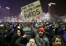 A protestor holds a sign reading "Ok, now I am really angry" during a demonstration in front of the government office in Bucharest, Romania, February 1, 2017. PHOTO BY REUTERS/Octav Ganea