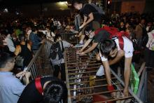Pro-democracy protesters set up new barricades after riot police retreated from a main road at Mong Kok shopping district in Hong Kong early
