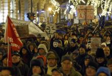 People hold flags and banners during an anti-government protest called by civil groups in Budapest, January 2, 2015. PHOTO BY REUTERS/Laszlo Balogh