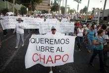 A protester holds a sign reading, "We want Chapo free" during a march in Culiacan, in this February 26, 2014 file photo. PHOTO BY REUTERS/Daniel Becerril