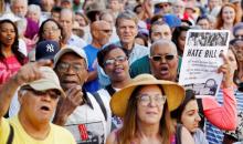 Members of the black community join a diverse crowd of protesters opposing North Carolina's HB2 "bathroom law" that restricts members of the LGBT community from using the bathroom of their choice, during a demonstration outside the state legislature in Raleigh, North Carolina, May 16, 2016. PHOTO BY REUTERS/Jonathan Drake