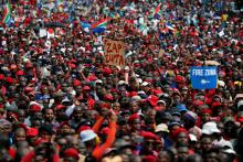 Protesters hold placards as they gather in South Africa's capital to protest against President Jacob Zuma in Pretoria, South Africa, April 12 ,2017. PHOTO BY REUTERS/Siphiwe Sibeko