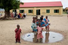 Pupils play in a puddle outside a block of classrooms at Hausari primary school in Michika village, northeast Nigeria, June 12, 2017. PHOTO BY REUTERS/Akintunde Akinleye