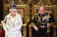 Britain's Queen Elizabeth waits to read the Queen's Speech to lawmakers in the House of Lords, next to Prince Philip, during the State Opening of Parliament in central London, May 9, 2012. PHOTO BY REUTERS/Oli Scarff