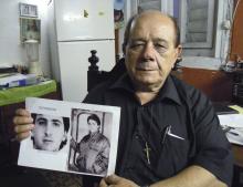 Raul Borges, 74, holds a picture of his son Ernesto Borges in his house in Havana, January 2, 2015. PHOTO BY REUTERS/David Adams
