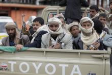 Shi'ite Houthi rebels ride a patrol truck in Sanaa