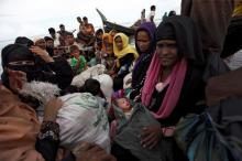Newly arrived Rohingya refugees board a boat as they transfer to a camp in Cox's Bazar, Bangladesh, October 2, 2017. PHOTO BY REUTERS/Cathal McNaughton