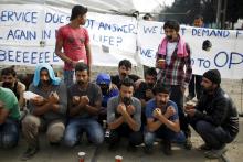 Migrants and refugees with their mouths taped stage a protest at a makeshift camp at the Greek-Macedonian border near the village of Idomeni, Greece, April 1, 2016. PHOTO BY REUTERS/Marko Djurica