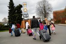 Syrian refugees arrive at the camp for refugees and migrants in Friedland, Germany, April 4, 2016. PHOTO BY REUTERS/Kai Pfaffenbach