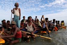 Rohingya refugees cross the Naf River with an improvised raft to reach to Bangladesh in Teknaf, Bangladesh, November 12, 2017. PHOTO BY REUTERS/Mohammad Ponir Hossain
