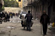 Residents walk in the rebel held town of Yalda, south Damascus, April 11, 2015. PHOTO BY REUTERS/Moayad Zaghmout