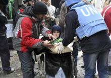 Residents receive food aid distributed by the U.N. Relief and Works Agency (UNRWA) at the besieged al-Yarmouk camp, south of Damascus February 4, 2014, in this handout released by Syria's national news agency SANA