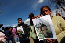 Residents hold pictures of their missing relative at the site where a fuel pipeline ruptured by suspected oil thieves exploded, in the municipality of Tlahuelilpan, state of Hidalgo, Mexico, January 19, 2019. PHOTO BY REUTERS/Henry Romero