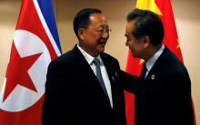 China's Foreign Minister Wang Yi (R) greets North Korea's Foreign Minister Ri Yong Ho before their bilateral meeting on the sidelines of the 50th Association of Southeast Asia Nations (ASEAN) Regional Forum (ARF) in Manila, Philippines, August 6, 2017. PHOTO BY REUTERS/Joe Campbell