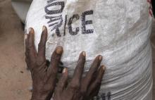 A newly arrived Somali refugee holds her bag of relief maize outside a distribution centre at the Dadaab refugee camp, near the Kenya-Somalia, July 23, 2011. PHOTO BY REUTERS/Barry Malone