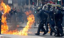 French CRS riot police protect themselves from flames during clashes at the traditional May Day labour union march in Paris, France, May 1, 2017. PHOTO BY REUTERS/Gonzalo Fuentes