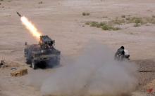 Members of Iraq's Shi'ite paramilitaries launch a rocket towards Islamic State militants in the outskirts of the city of Falluja, in the province of Anbar, Iraq, July 12, 2015. PHOTO BY REUTERS/Stringer