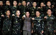 Philippine President Rodrigo Duterte makes a "fist bump", his May presidential elections campaign gesture, with soldiers during a visit at Capinpin military camp in Tanay, Rizal in the Philippines, August 24, 2016. PHOTO BY REUTERS/Erik De Castro
