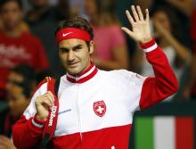 Switzerland's Roger Federer waves as he arrives for his Davis Cup semi-final tennis match against Italy's Fabio Fognini at the Palexpo in Geneva
