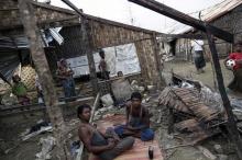 Rohingya people pass their time in a damaged shelter in Rohingya IDP camp outside Sittwe, Rakhine state, August 4, 2015. PHOTO BY REUTERS/Soe Zeya Tun