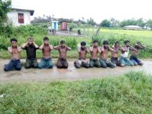 Ten Rohingya Muslim men with their hands bound kneel in Inn Din village September 1, 2017. PHOTO BY REUTERS