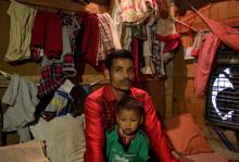 Sahidullah, a man from the Rohingya community, holds his son on his lap as he speaks with Reuters inside his shack at a camp on the outskirts of Jammu, October 5, 2018. PHOTO BY REUTERS/Mukesh Gupta